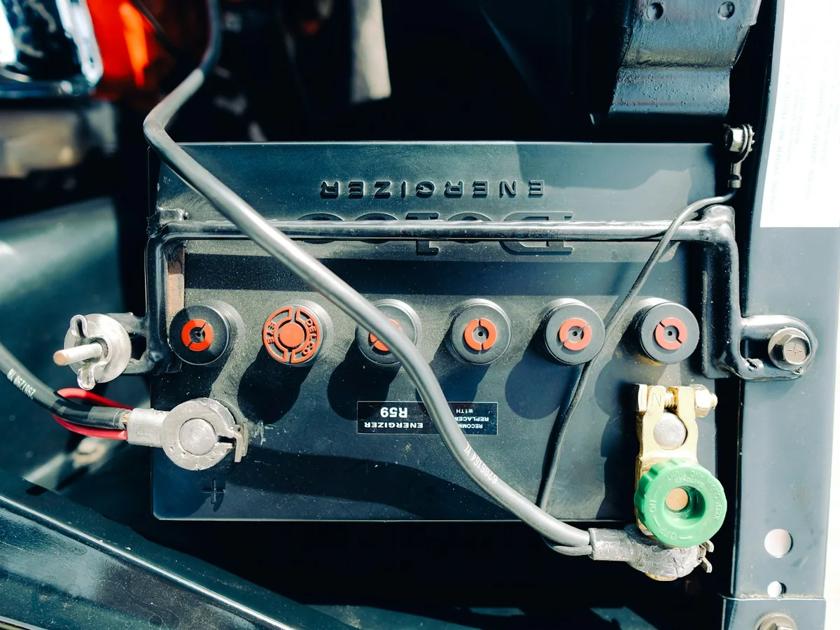Technician connecting a new 12-volt battery to a Generac standby generator in Atlanta, GA