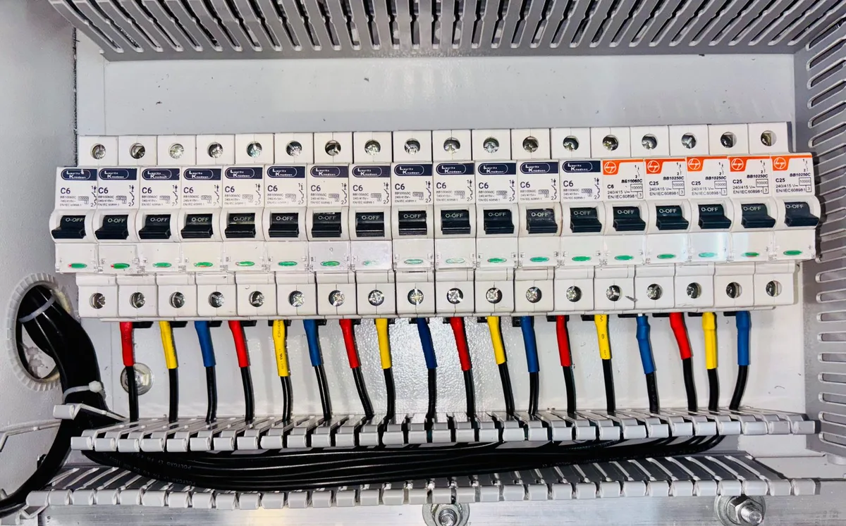 An electrician wiring an automatic transfer switch and electrical panel for a home standby generator in Atlanta, GA