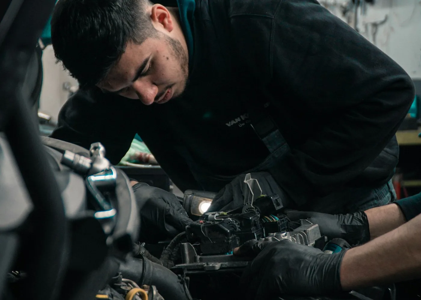 Technician diagnosing and repairing a generator engine with a work light in Atlanta, GA